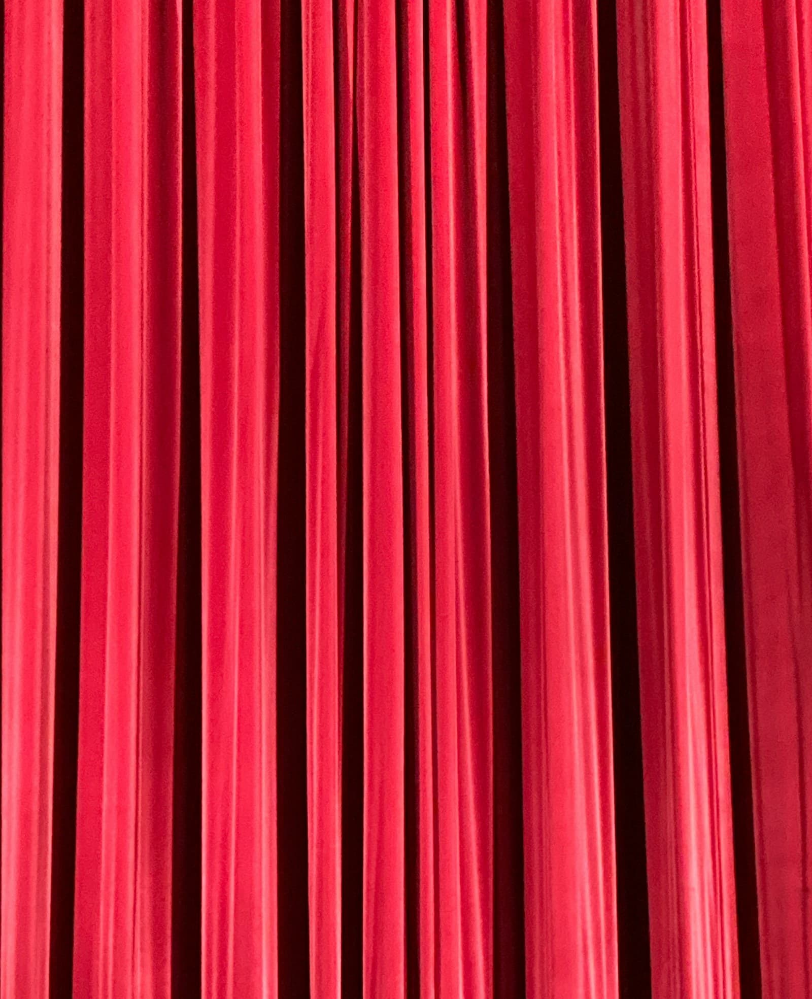 Vertical red velvet stage curtains for event backdrop rental